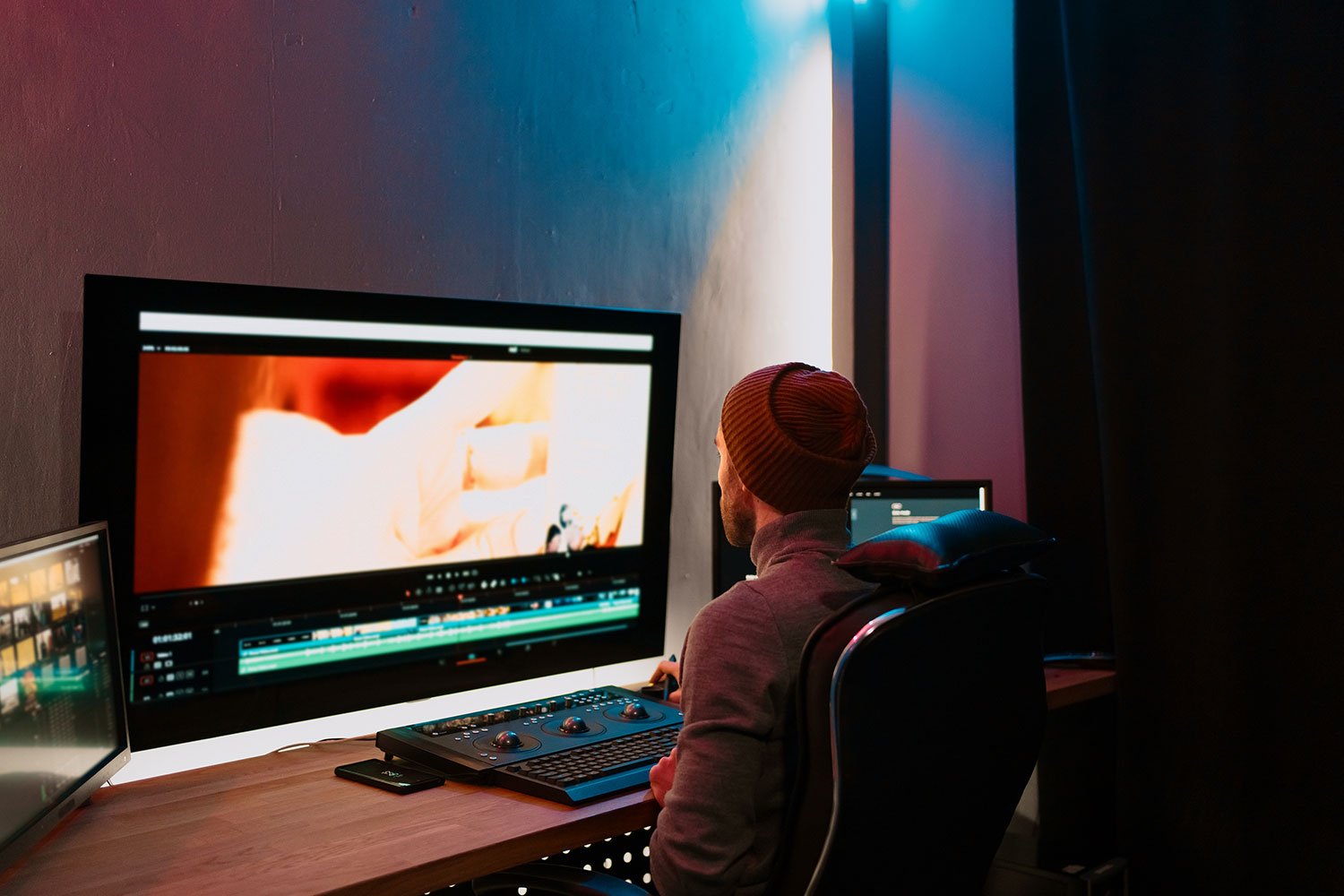 Video editor working on post-production in a studio